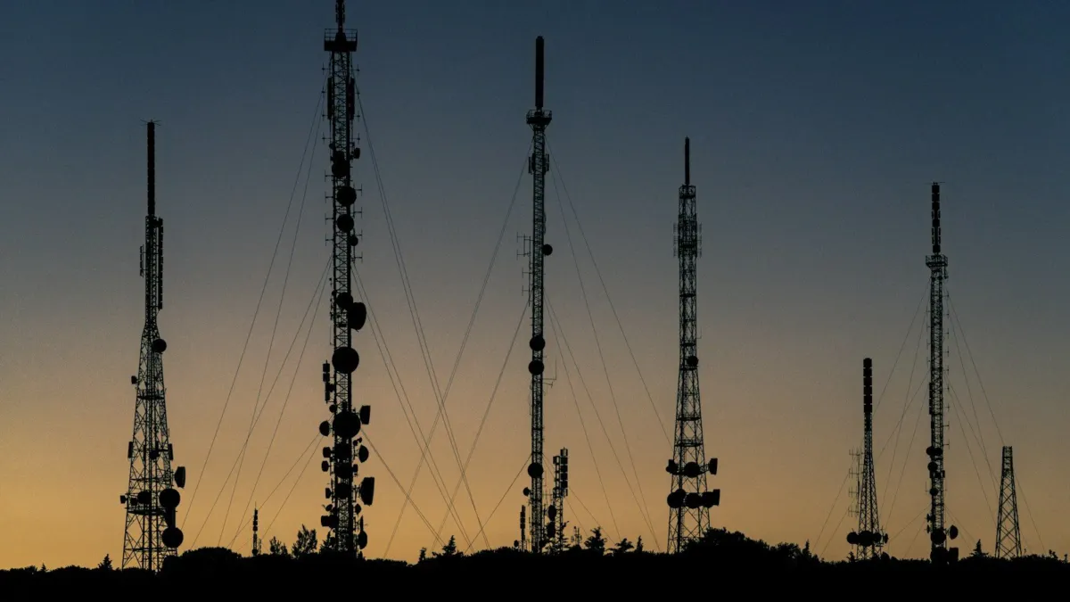 Tall radio transmitter towers used for international broadcasting against an open sky