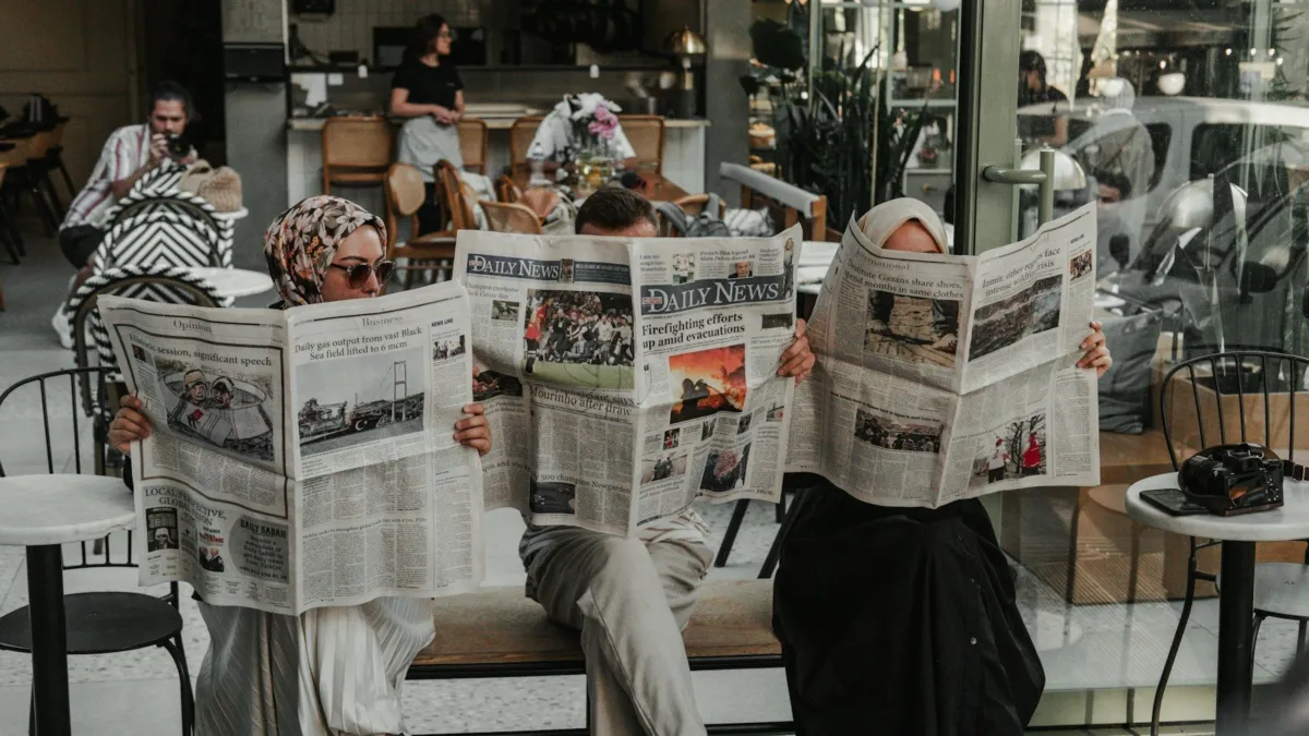 Reader comparing international newspapers and a phone to find reliable global news