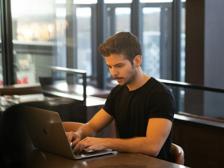 Editorial team writer researching a global story on a laptop